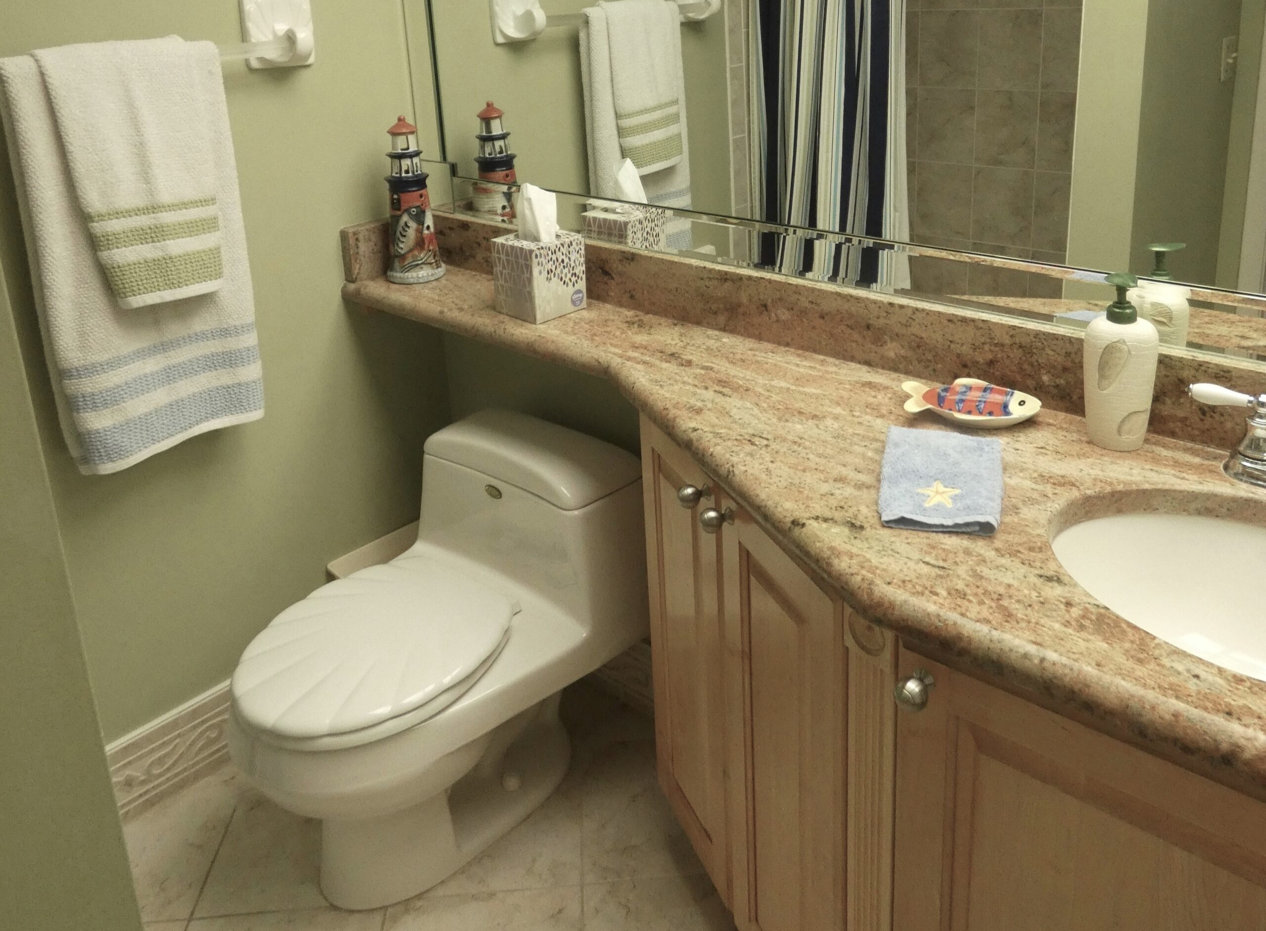 Guest bathroom with granite vanity and walk-in shower in Sand Key monthly beach condo