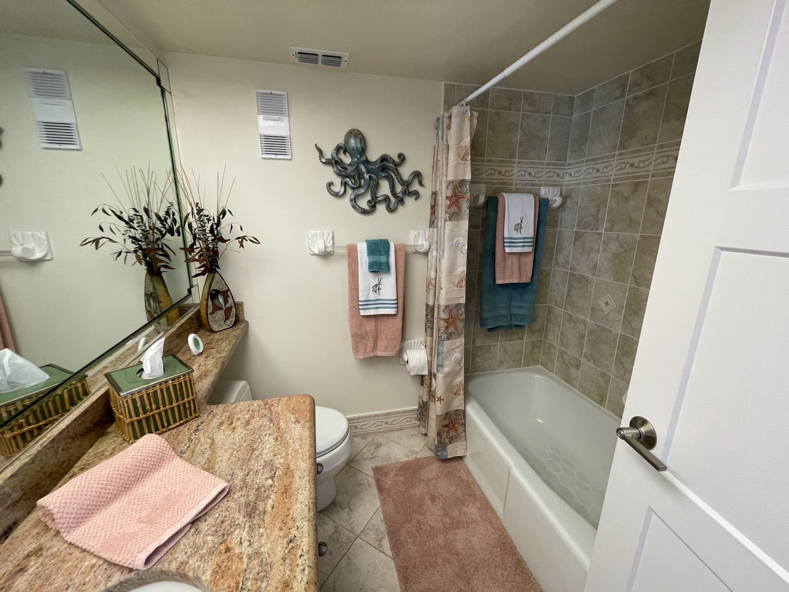 Master bathroom with granite vanity and tub shower in Sand Key Clearwater monthly rental condo