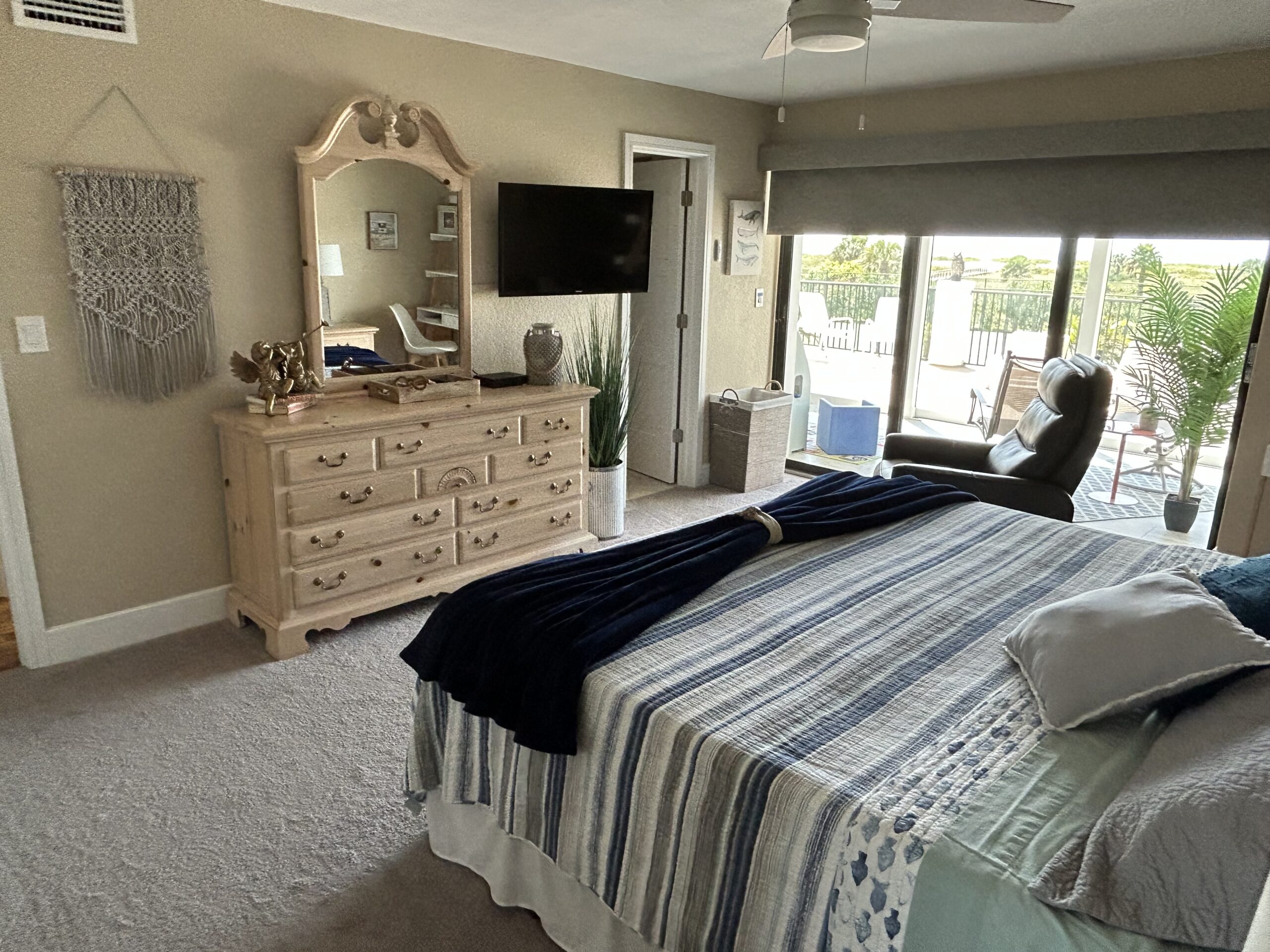 Master bedroom with balcony access and seating in Sand Key Florida monthly condo rental