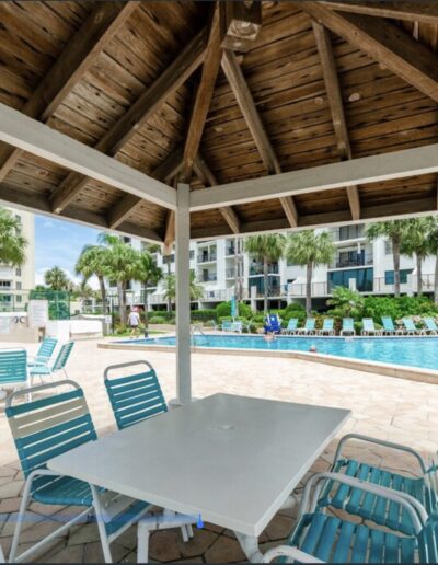 Poolside cabana with seating and umbrellas at Sand Key condo near Clearwater Beach