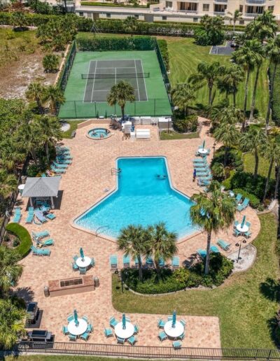 Aerial of resort-style pool, hot tub, and lounge areas at Sand Key condo