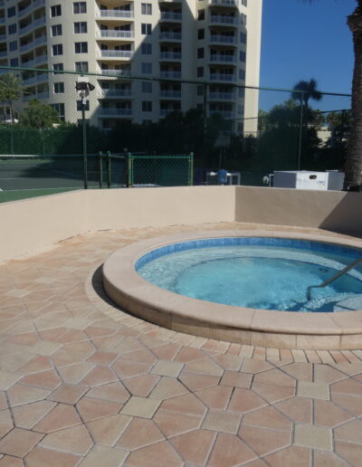 Resort-style jacuzzi with lounge chairs at Sand Key Clearwater beach condo